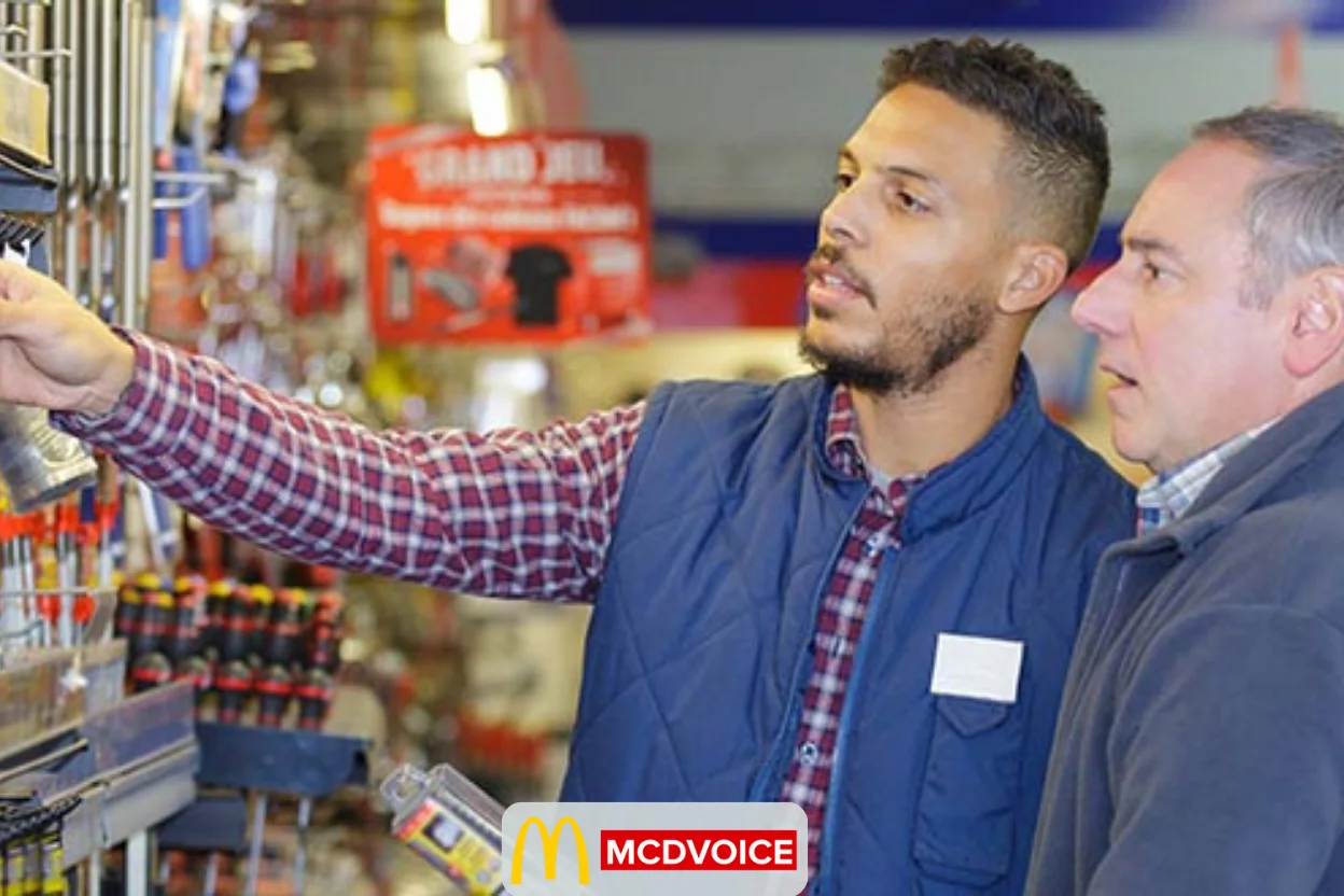 Ace Hardware employee helping a customer choose products in store
