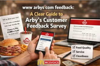 Customer completing Arby’s feedback survey on phone with receipt, meal, and laptop showing survey questions.